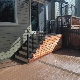 Stylish backyard deck with black railings and a minimalist design.