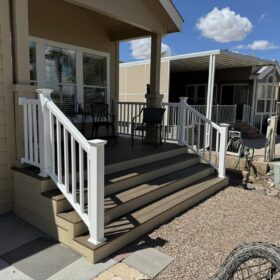 Elevated composite deck with white railings overlooking a spacious backyard.