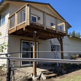 Elevated wooden deck attached to a modern house