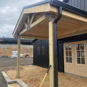 Modern pergola with robust wooden beams and metal brackets, showcasing innovative outdoor architecture.