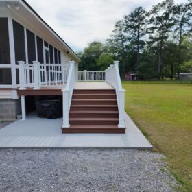 White screened deck with tools visible, enhancing a suburban home.