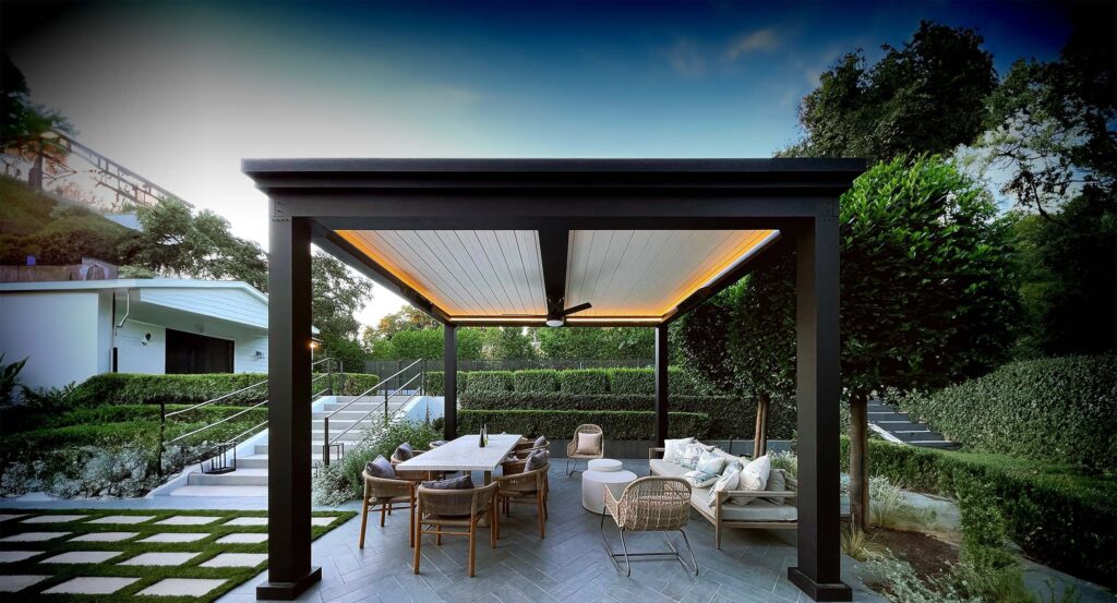 Wooden pergola with string lights over outdoor dining area on stone patio