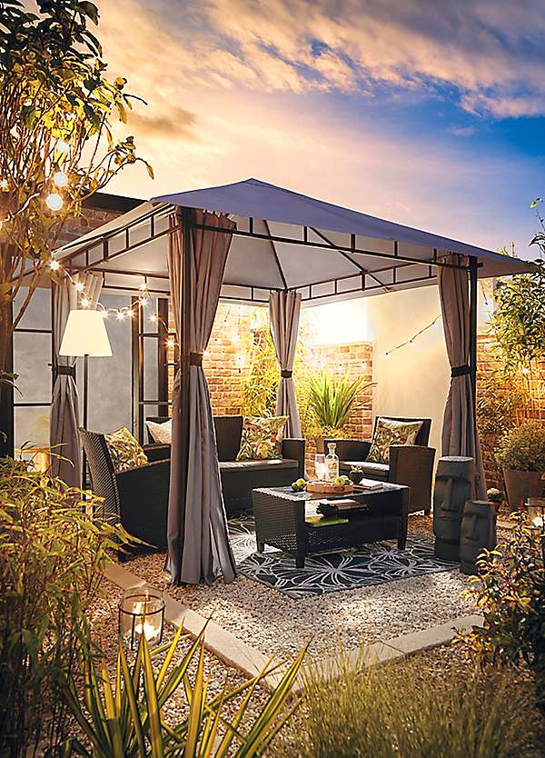 Gazebo with shingled roof in a landscaped garden surrounded by greenery.