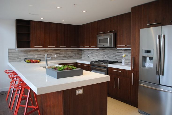 Modern kitchen renovation with custom cabinetry, quartz countertops, and upgraded lighting.