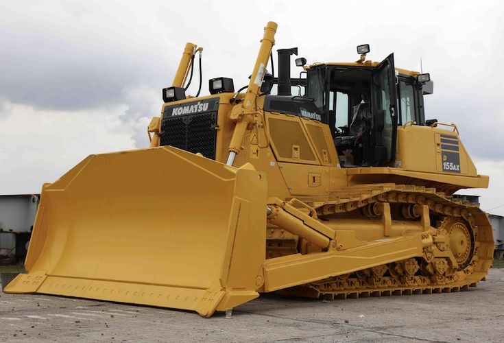 Large yellow Komatsu bulldozer used for demolition and construction projects.