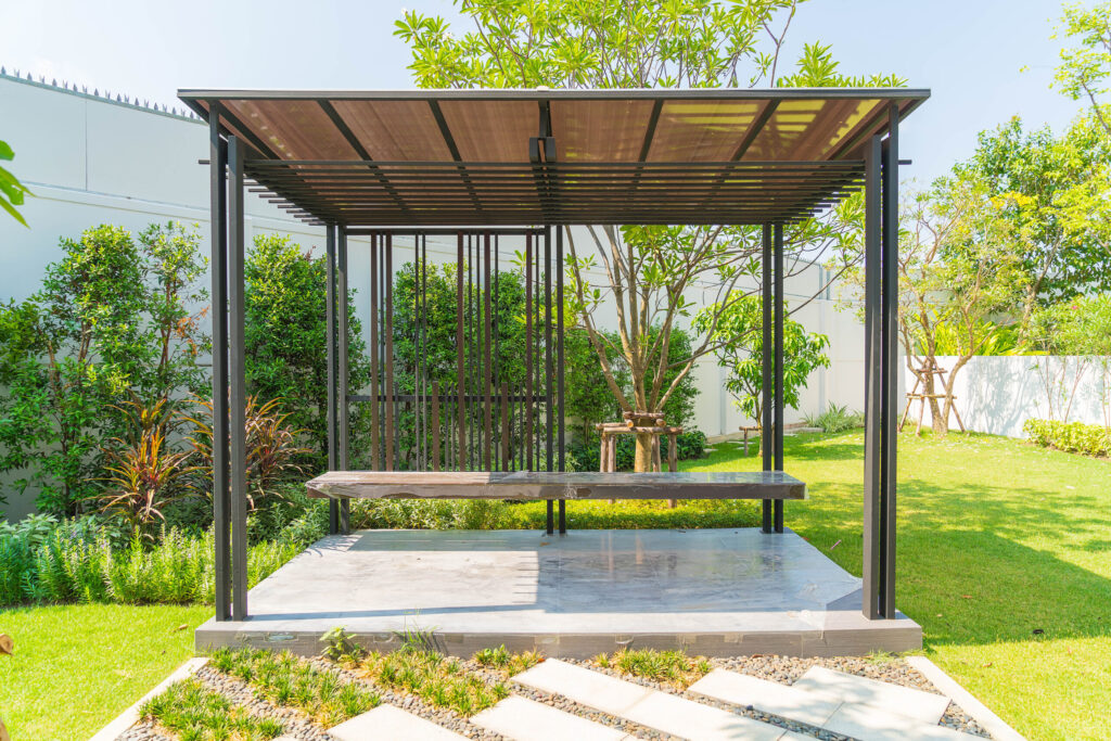 Pavilion in garden under blue sky