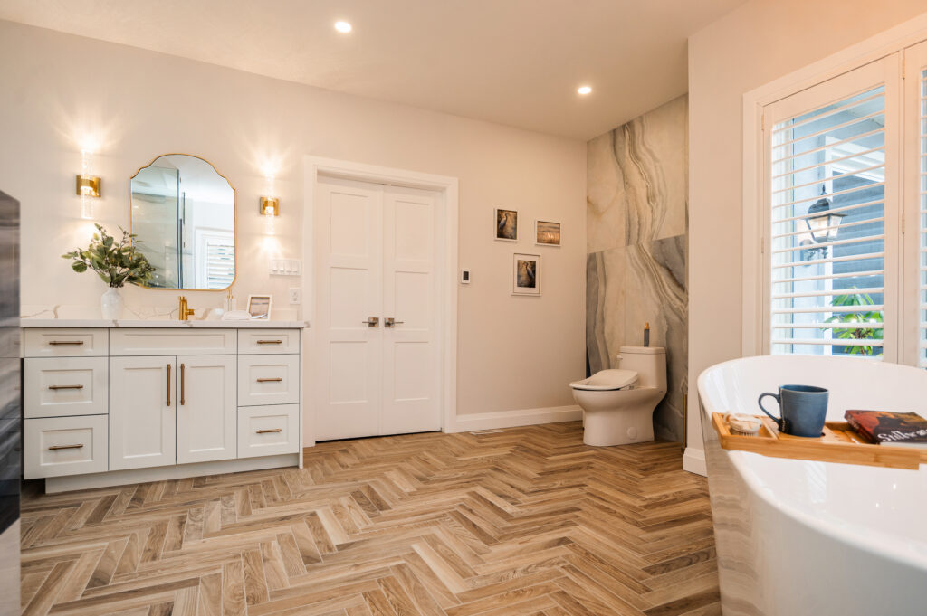Modern bathroom renovation with glass shower, vanity, and updated fixtures.