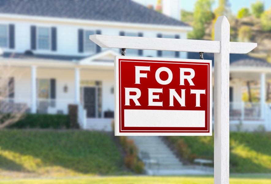 Modern two-story house with a front yard and a red "For Rent" sign, available for lease.