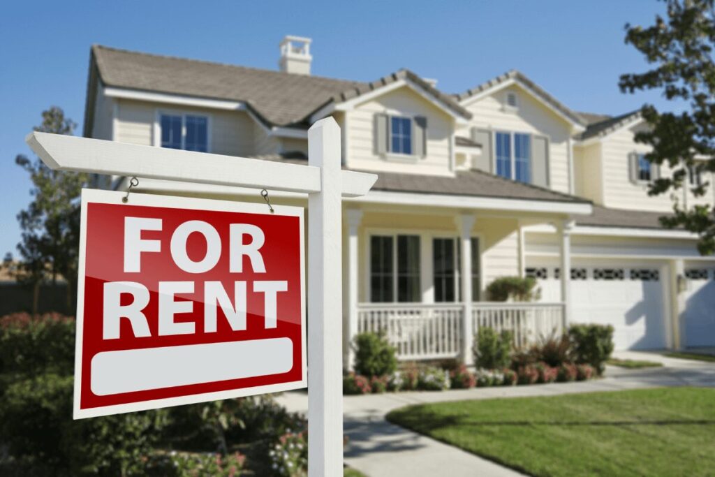 Modern two-story house with a front yard and a red "For Rent" sign, available for lease.